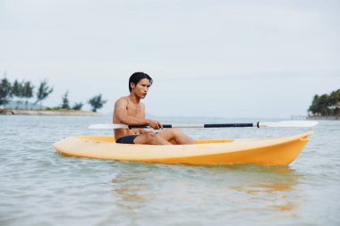 Asyalı Adam Tropikal Sahilde Eğlenceli Kayak Aktivitesi Keyfini Çıkartıyor
