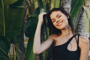 Siyah Tek Parça Giyinen Tropik Cennet Kadını Palmiye Ağaçlarının Önünde Banyo Poz Veriyor