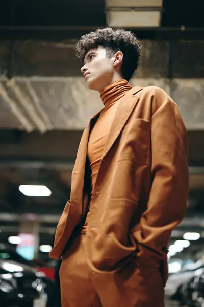 stock image A fashion forward individual wearing an eye catching orange ensemble, exuding confidence in an urban setting