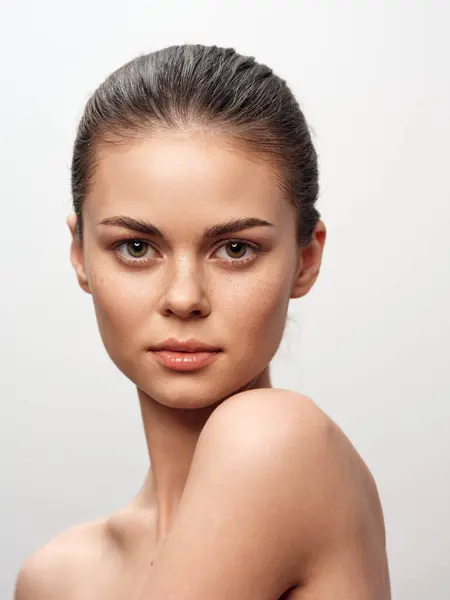 stock image Elegant young female posing in front of a plain white background in a professional photoshoot