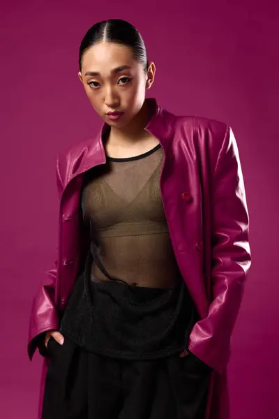 stock image Fashion, asian, beauty, woman, purple leather jacket, black pants, posing, purple background. an elegant asian woman wearing a stylish purple leather jacket and black pants, striking a pose against a