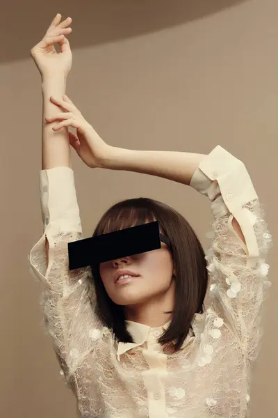 stock image Blindfolded woman posing with hands on head and arms stretched forward, captured in a dramatic and expressive stance