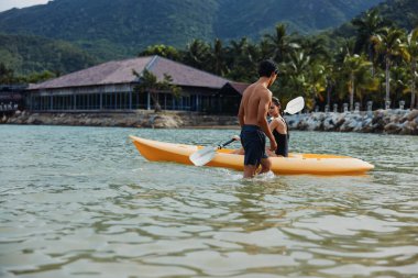 Kaygısız çift güzel tropikal gölde kayak yapıyor, açık havada eğleniyor.