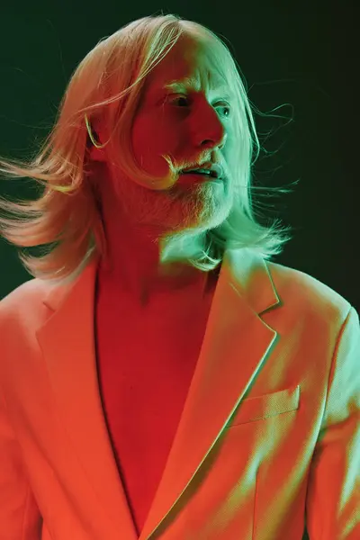 stock image This artistic portrait features a man with flowing long hair, showcasing a white suit Bold red and green lighting adds a dramatic effect, highlighting the subject s unique style and expression