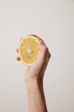 Citrus fruit lemon in a persons hand on a plain white background. close-up shot, vibrant yellow color, fresh and juicy. perfect for healthy lifestyle, cooking, and nutrition concepts. clipart