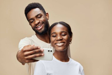 Mutlu Afrikalı çift mutlu bir özçekim anı yaşıyor, sıcak bir zemin üzerinde mutluluk ve beraberliği ifade ediyorlar, yaşam tarzı ve ilişki temaları için mükemmel.