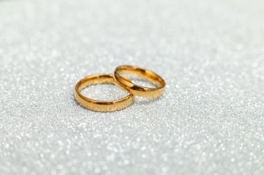 Will you marry me. Two golden wedding rings on silver glitter background. Engagement marriage proposal wedding concept. St. Valentines Day postcard. Banner on valentines day. Copy space