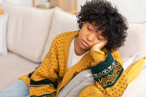 African american sad thoughtful girl at home. Young african woman feels depressed offended lonely upset suffers from abuse harassment heartbreak. Grieving violence victim has psychological problem