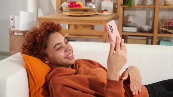 African American Girl Lying Couch Holding Smartphone Having Video Chat — Video