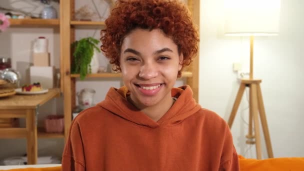 Beautiful African American Girl Afro Hairstyle Smiling Sitting Sofa Home — Stockvideo