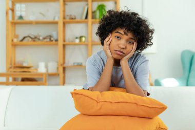 African american sad thoughtful girl at home. Young african woman feels depressed offended lonely upset suffers from abuse harassment heartbreak. Grieving violence victim has psychological problem