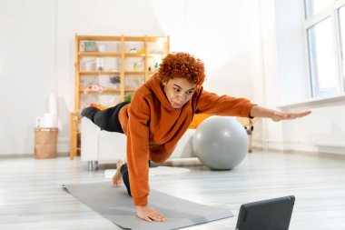 Fitness Workout training. Young healthy fit african girl doing sports exercise on yoga mat on floor at home. Athletic woman in sportswear have training workout for weight loss. Sport and fitness