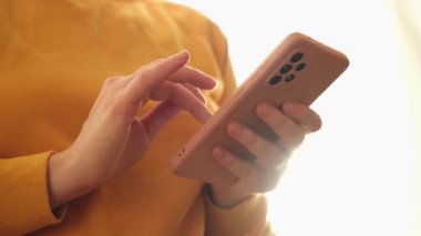 Cep telefonu tutan kadın uygulamayı kullanarak ekran parşömen sayfasına dokunuyor. Akıllı telefon cep telefonu aygıtı ellerinde. İnternet haber içeriği uygulamaları cep telefonu bağımlılığı kavramı