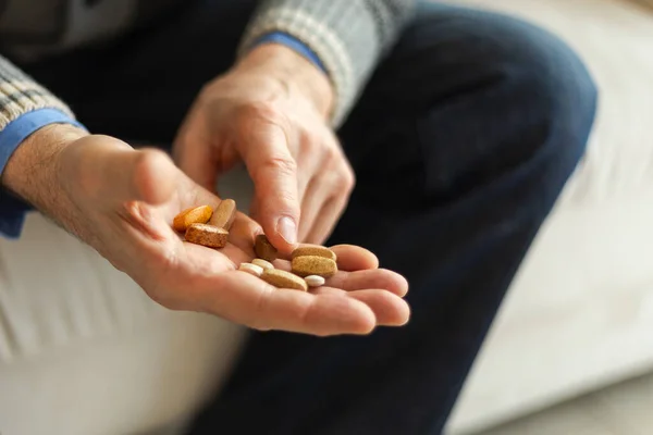 Hands with pills. Senior man hands holding medical pill. Mature old senior grandfather taking medication cure pills vitamin. Age prescription medicine healthcare therapy concept