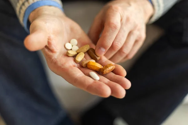 Hands with pills. Senior man hands holding medical pill. Mature old senior grandfather taking medication cure pills vitamin. Age prescription medicine healthcare therapy concept