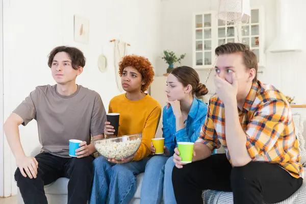 Group of friends watching sport match soccer football game on tv at home. Football fans disappointed missing goal loosing game. Friendship sports entertainment. Buddies watching championship together