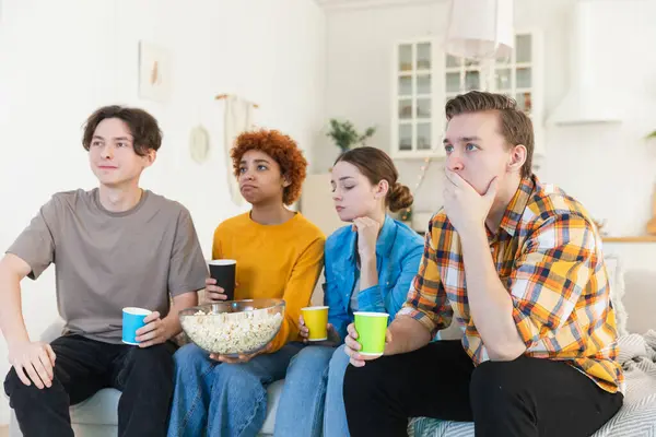 Group of friends watching sport match soccer football game on tv at home. Football fans disappointed missing goal loosing game. Friendship sports entertainment. Buddies watching championship together