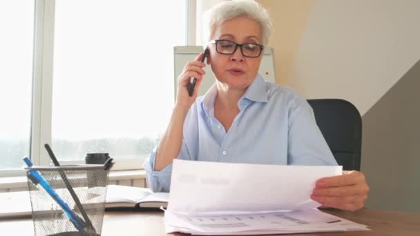 Mujer Mayor Mediana Edad Hablando Teléfono Inteligente Lectura Documento Papel — Vídeo de stock