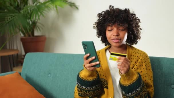 African American Woman Shopping Online Holding Smartphone Paying Gold Credit — Stockvideo