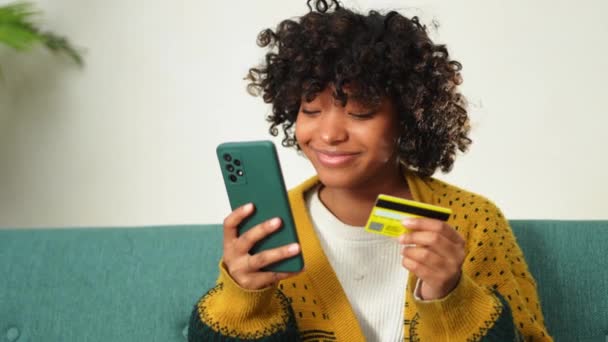 African American Woman Shopping Online Holding Smartphone Paying Gold Credit — Stock videók