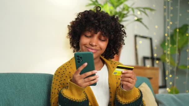 African American Woman Shopping Online Holding Smartphone Paying Gold Credit — Stockvideo