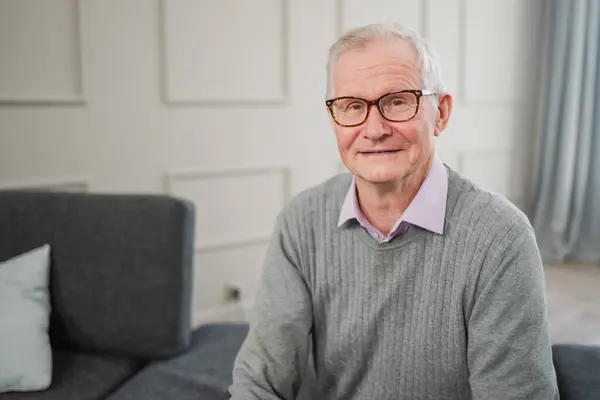 Stock image Portrait of confident stylish European middle aged senior man at home. Older mature 70s man smiling. Happy attractive senior grandfather looking camera close up face headshot portrait. Happy people