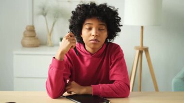 Happy african american teen girl blogger smiling face talking to webcam recording vlog. Social media influencer woman streaming making video call at home. Headshot portrait selfie webcamera view