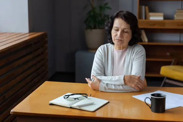 stock image Sad tired ill sick lonely disappointed older senior woman sitting at home alone. Unhappy mature grandmother experiencing grief relative death bad news. Stressed elder lady suffering from loneliness