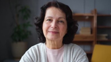Kendine güveni tam orta yaşlı Avrupalı bir kadının portresi. Evde gülümseyen 60 'lı yaşlarda olgun bir kadın. Mutlu, çekici, son sınıf öğrencisi, kamera görüntüsü, yüz portresi. Mutlu insanlar.
