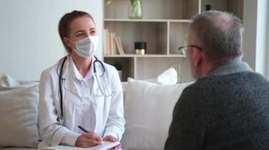 Doktor muayenehanesinde ya da evde yaşlı bir adamı muayene eden kadın doktor. Yaşlı hasta ve doktorun hastane odasında muayeneleri var. Tıbbi sağlık hizmetleri sağlık kontrolü. Doktoru ziyaret et.