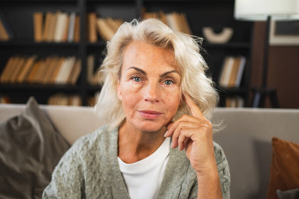 Portrait of confident stylish European middle aged senior woman. Older mature 60s lady smiling at home. Happy attractive senior female looking camera close up face headshot portrait. Happy people