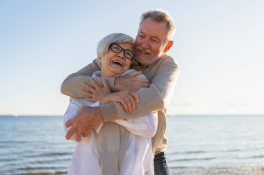 Yaşlı bir çift kumsalda yürüyüş yaparken kucaklaşıp eğleniyorlar. Yaşlı karı şefkatle kucaklaşıyor aşk tatlı bir bağın tadını çıkarıyor. Büyükannem ve büyükbabam birlikte. Aile anı aşkı