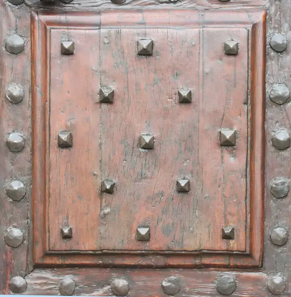 Antique door with wood and nails and studs