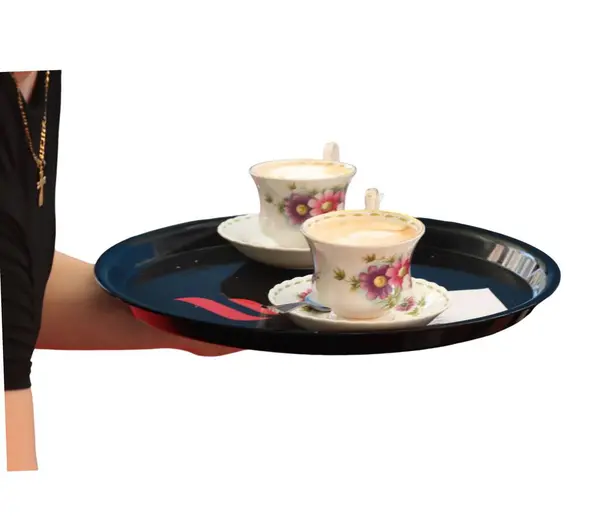 stock image Waitress serving two cappuccinos on a black tray