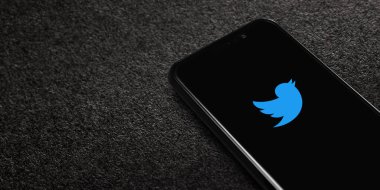 Twitter logo on smartphone screen on black textured background. Twitter is a microblogging and social networking service. Elon Musk closes Twitter acquisition deal. Moscow, Russia - October 27, 2022.