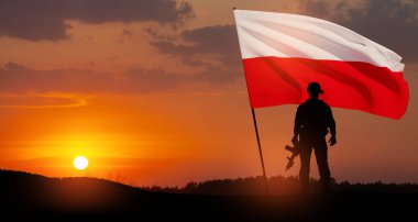 Silhouette of soldier with national flag on background of sunset. Polish Armed Forces. Armed Forces of the Republic of Poland. Polish army.