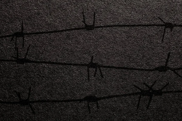 International Holocaust Remembrance Day. Barbed wire on a black background with place for text. Holocaust Remembrance Day Poster, January 27.