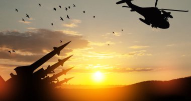 Missiles are aimed at a helicopter in the sky at sunset. Nuclear bomb, chemical weapons, missile defense, a system of salvo fire.