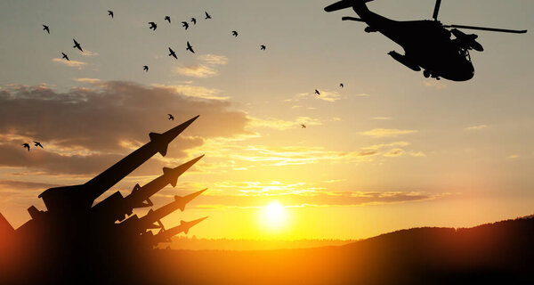 Ракеты нацелены на вертолет в небе на закате. Ядерная бомба, химическое оружие, противоракетная оборона, система залпового огня.