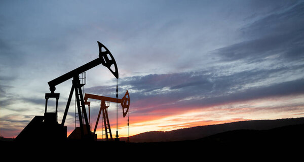 The change in oil prices caused by the war. Oil prices are rising because of the global crisis. Oil drilling derricks at desert oilfield. Crude oil production from the ground. Petroleum production.