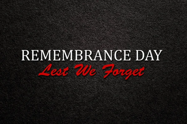 Text Remembrance Day Lest We Forget on black textured background. Remembrance Day, Memorial Day, Anzac Day in New Zealand, Australia, Canada and Great Britain.