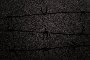 International Holocaust Remembrance Day. Barbed wire on a black background with place for text. January 27.