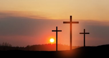 Christian cross on hill outdoors at sunrise. Resurrection of Jesus. Concept photo.