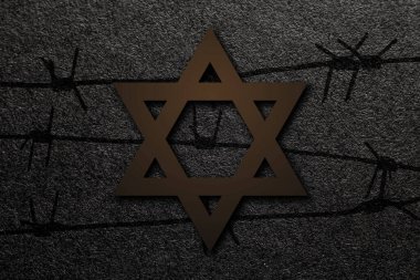 International Holocaust Remembrance Day. Star of David with barbed wire on a black background. Holocaust Remembrance Day Poster, January 27.