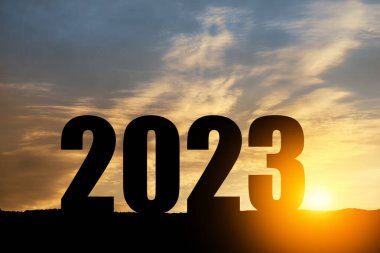 Silhouette 2023 with sunset sky at mountain and number like 2023 abstract background. Concept of start with strategy, win, plan, goal and objective target.