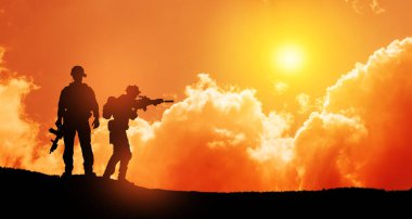 Silhouettes of soldiers standing against the backdrop of a sunset. Greeting card for Veterans Day, Memorial Day, Independence Day. USA celebration. Concept - patriotism, protection, remember honor.
