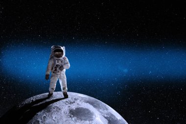 Astronaut at the spacewalk on the moon. National Moon Day. Space Exploration Day. Elements of this image furnished by NASA.