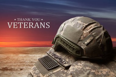 USA military uniform with insignias on old wooden table on sunset sky background. Memorial Day or Veterans day concept.