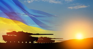 Silhouettes of army tanks at sunset sky background with Ukrainian flag. Shipping a huge, wide-ranging package of heavy weapons to Ukraine
