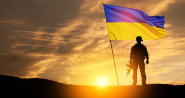 Flag of Ukraine with silhouette of soldier against the sunrise or sunset. Concept - armed forces of Ukraine. Relationship between Ukraine and Russia. clipart